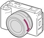 Illustration showing how to turn the lens clockwise with the camera facing toward you