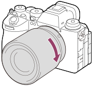 Illustratie die weergeeft hoe u de lens rechtsom draait met de camera naar u toe gekeerd