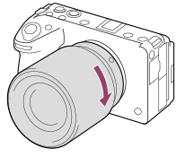Illustration showing how to turn the lens clockwise with the camera facing toward you