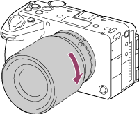Illustration indicating direction to rotate lens