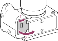 Illustratie met de richting om het batterijdeksel te openen
