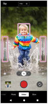 Image showing the focus frame on the subject, the color adjustment slider on the left side, and the brightness adjustment slider on the right side, in the viewfinder of the [Video] mode.